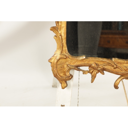 1350 - AN 18TH CENTURY GILT CARVED WOOD ROCOCO STYLE HANGING MIRROR with scrolled leaf carved surround with... 