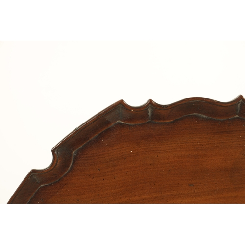 1352 - A GEORGE III MAHOGANY TILT-TOP TABLE with pie crust top above a tapering ring-turned stem and shaped... 