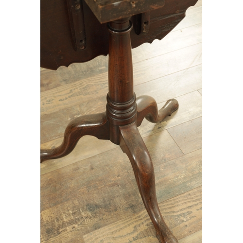 1352 - A GEORGE III MAHOGANY TILT-TOP TABLE with pie crust top above a tapering ring-turned stem and shaped... 