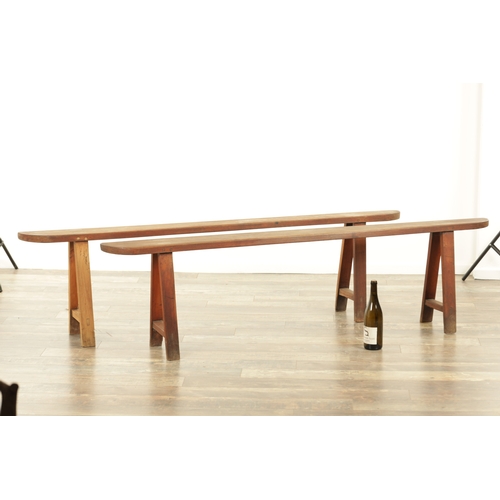 1353 - A PAIR OF 19TH CENTURY WALNUT NARROW BENCHES with shaped ends and splayed leg supports. (182cm wide ... 