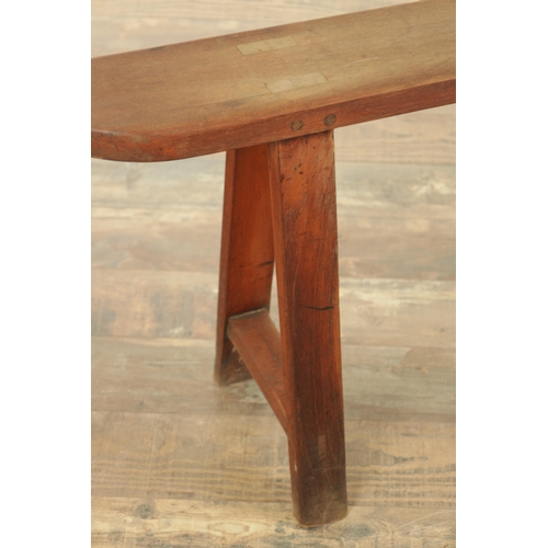 1353 - A PAIR OF 19TH CENTURY WALNUT NARROW BENCHES with shaped ends and splayed leg supports. (182cm wide ... 