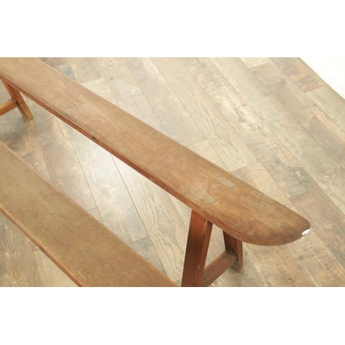 1353 - A PAIR OF 19TH CENTURY WALNUT NARROW BENCHES with shaped ends and splayed leg supports. (182cm wide ... 