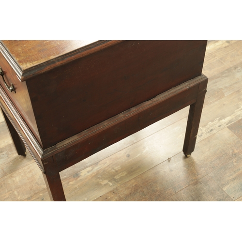 1366 - A GEORGE III MAHOGANY CELLARETTE ON STAND with hinged top and side carrying handles; raised on squar... 