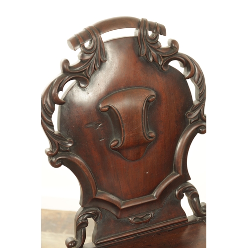 1368 - A PAIR OF 19TH CENTURY MAHOGANY HALL CHAIRS with leaf-carved shaped backs and raised on ring turned ... 