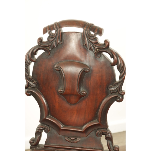 1368 - A PAIR OF 19TH CENTURY MAHOGANY HALL CHAIRS with leaf-carved shaped backs and raised on ring turned ... 