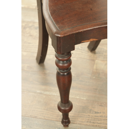 1368 - A PAIR OF 19TH CENTURY MAHOGANY HALL CHAIRS with leaf-carved shaped backs and raised on ring turned ... 