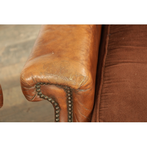 1376 - A PAIR OF EDWARDIAN OAK AND TAN LEATHER UPHOLSTERED ARMCHAIRS with loose cushion seats and carved oa... 