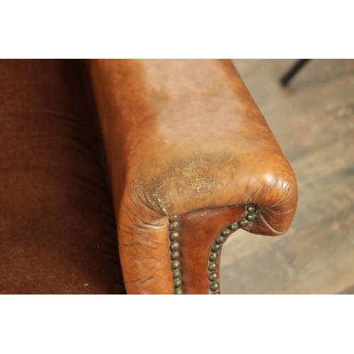 1376 - A PAIR OF EDWARDIAN OAK AND TAN LEATHER UPHOLSTERED ARMCHAIRS with loose cushion seats and carved oa... 