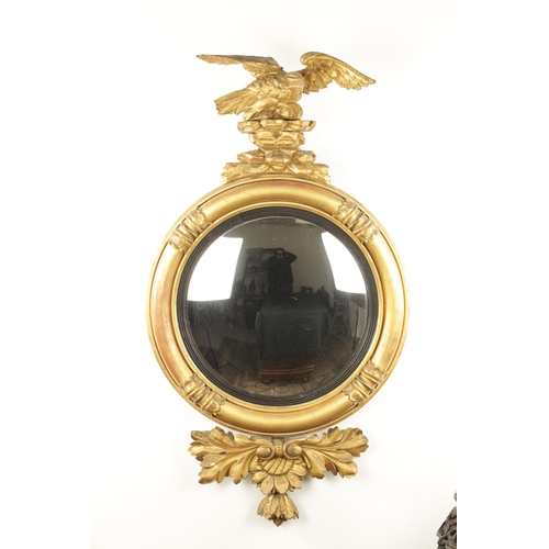 1380 - A REGENCY CARVED GILT GESSO CONVEX MIRROR with panelled leaf carved border, ebonised inner slip and ... 