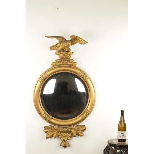 1380 - A REGENCY CARVED GILT GESSO CONVEX MIRROR with panelled leaf carved border, ebonised inner slip and ... 