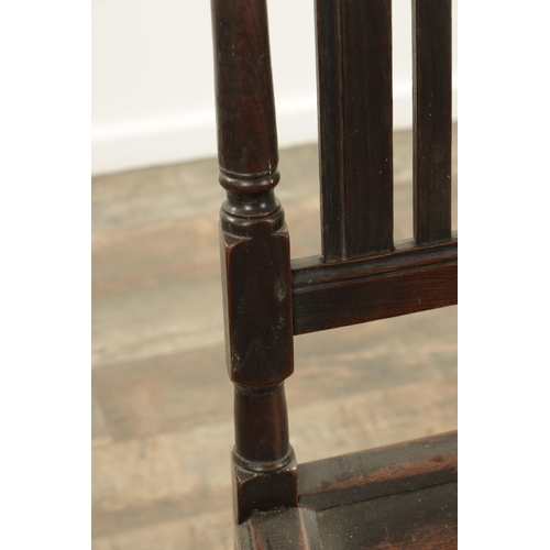 1383 - A CHARLES II OAK HALL CHAIR with a raised slatted back and panelled seat above turned legs and carve... 