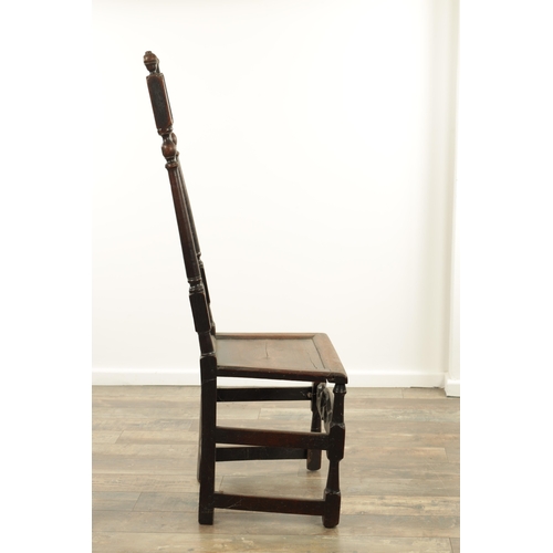 1383 - A CHARLES II OAK HALL CHAIR with a raised slatted back and panelled seat above turned legs and carve... 