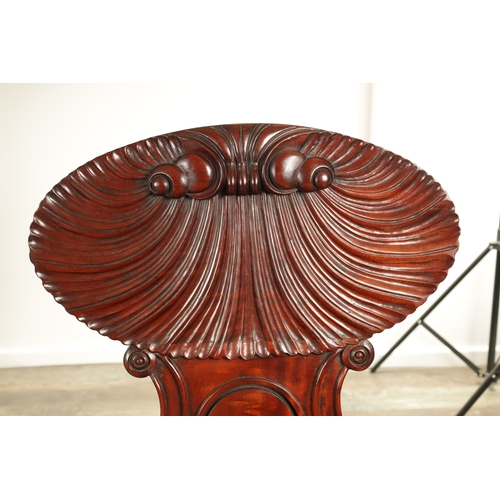 1389 - A PAIR OF REGENCY STYLE MAHOGANY HALL CHAIRS with dished seats and sabre leaf carved leg supports. (... 