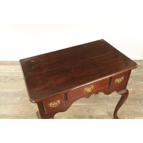 1393 - A GEORGE II OAK LOWBOY with moulded edge top fitted pullout candle side to one side above three frie... 