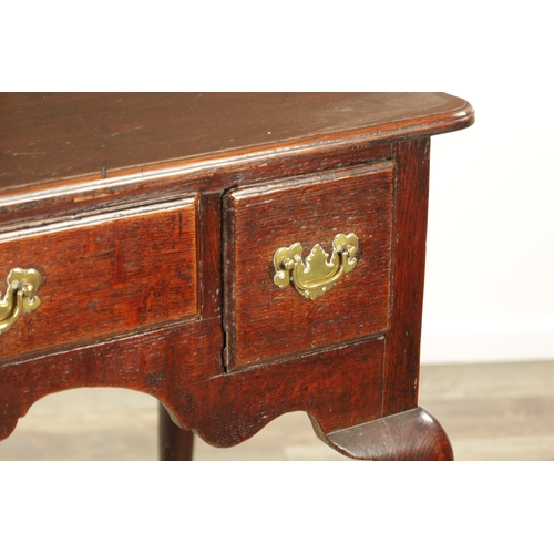 1393 - A GEORGE II OAK LOWBOY with moulded edge top fitted pullout candle side to one side above three frie... 