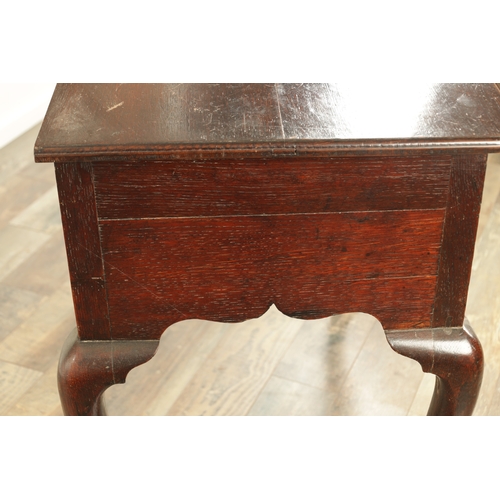 1393 - A GEORGE II OAK LOWBOY with moulded edge top fitted pullout candle side to one side above three frie... 