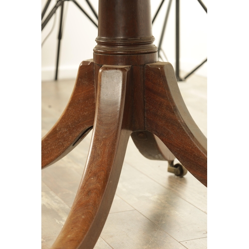 1403 - A GEORGE III MAHOGANY OVAL TILT TOP BREAKFAST TABLE with one piece top raised on a gun barrel stem w... 