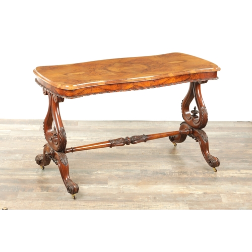 1416 - A VICTORIAN BURR WALNUT SERPENTINE SHAPED LIBRARY TABLE with moulded edge top above leaf carved end ... 