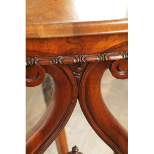 1416 - A VICTORIAN BURR WALNUT SERPENTINE SHAPED LIBRARY TABLE with moulded edge top above leaf carved end ... 