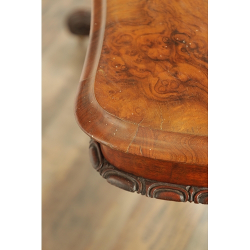 1416 - A VICTORIAN BURR WALNUT SERPENTINE SHAPED LIBRARY TABLE with moulded edge top above leaf carved end ... 