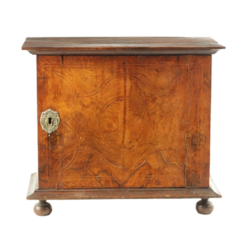 1417 - A WILLIAM AND MARY GEOMETRIC INLAID WALNUT SPICE CABINET with hinged door revealing a bank of small ... 