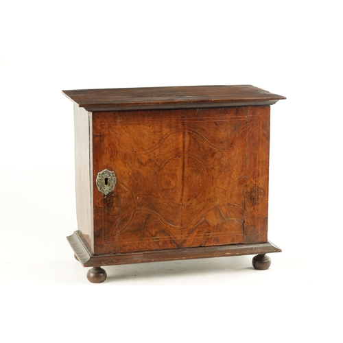 1417 - A WILLIAM AND MARY GEOMETRIC INLAID WALNUT SPICE CABINET with hinged door revealing a bank of small ... 