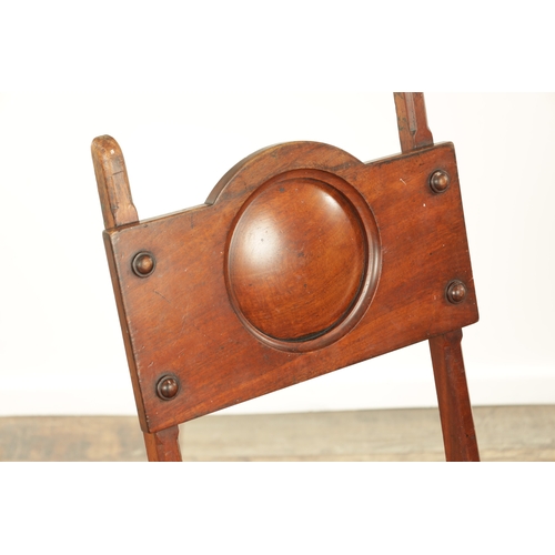 1420 - AN ARTS AND CRAFTS WALNUT METAMORPHIC LIBRARY CHAIR / STEPS with roundel shaped back above a hinged ... 