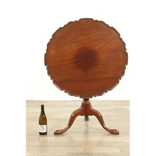 1422 - A GEORGE III MAHOGANY TILT-TOP TABLE with one piece pie crust top above a tapering stem with cabriol... 