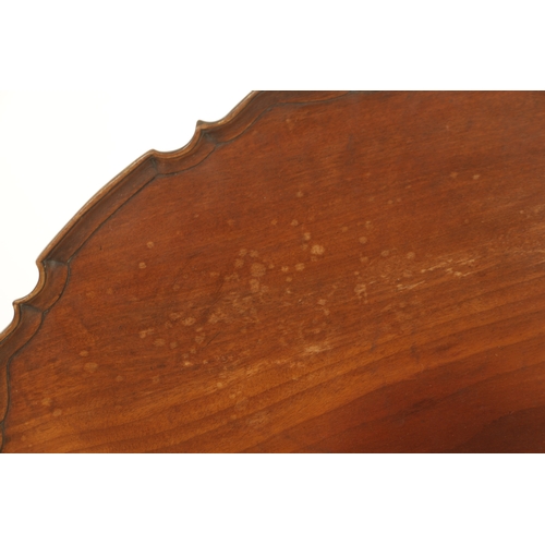 1422 - A GEORGE III MAHOGANY TILT-TOP TABLE with one piece pie crust top above a tapering stem with cabriol... 