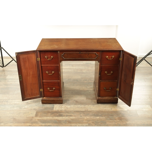 1423 - A GEORGE III MAHOGANY KNEEHOLE DESK with panelled central drawer and hinged sides revealing banks of... 