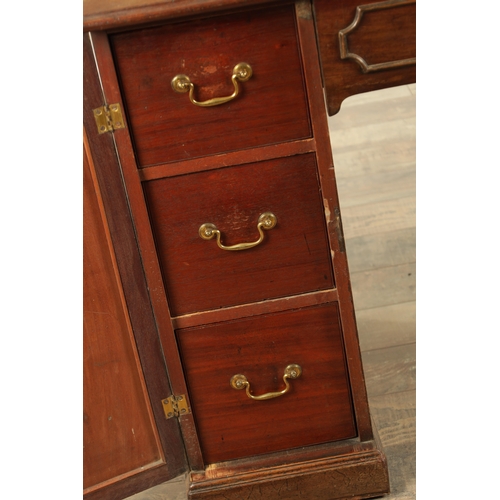 1423 - A GEORGE III MAHOGANY KNEEHOLE DESK with panelled central drawer and hinged sides revealing banks of... 