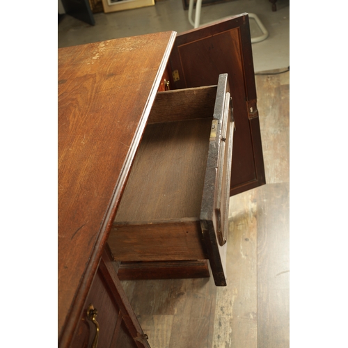 1423 - A GEORGE III MAHOGANY KNEEHOLE DESK with panelled central drawer and hinged sides revealing banks of... 