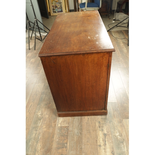 1423 - A GEORGE III MAHOGANY KNEEHOLE DESK with panelled central drawer and hinged sides revealing banks of... 