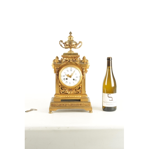 969 - A LATE 19TH CENTURY FRENCH ORMOLU MANTEL CLOCK with large urn and swag finial above column case with... 