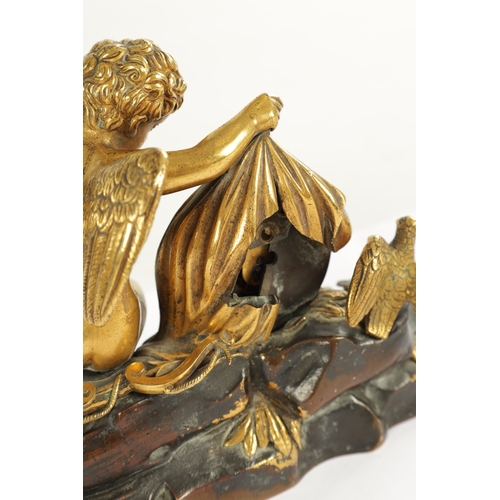 970 - A REGENCY ENGLISH BRONZE AND GILT BRONZE SMALL MANTEL CLOCK modelled with a cherub laying in a natur... 