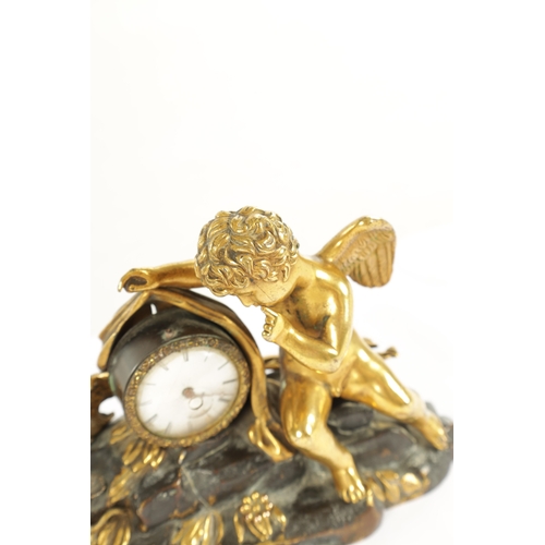 970 - A REGENCY ENGLISH BRONZE AND GILT BRONZE SMALL MANTEL CLOCK modelled with a cherub laying in a natur... 