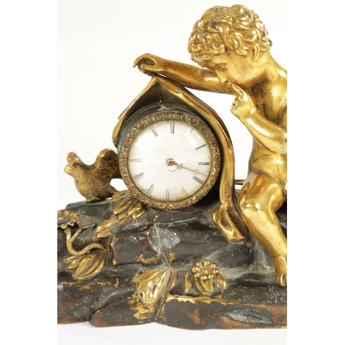 970 - A REGENCY ENGLISH BRONZE AND GILT BRONZE SMALL MANTEL CLOCK modelled with a cherub laying in a natur... 