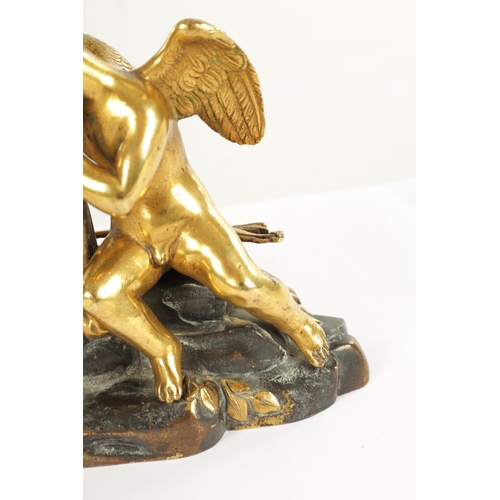 970 - A REGENCY ENGLISH BRONZE AND GILT BRONZE SMALL MANTEL CLOCK modelled with a cherub laying in a natur... 