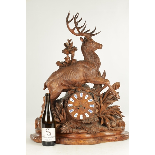 975 - A LARGE 19TH CENTURY CARVED LINDEN WOOD BLACK FOREST MANTEL CLOCK modelled as a stag amongst foliage... 