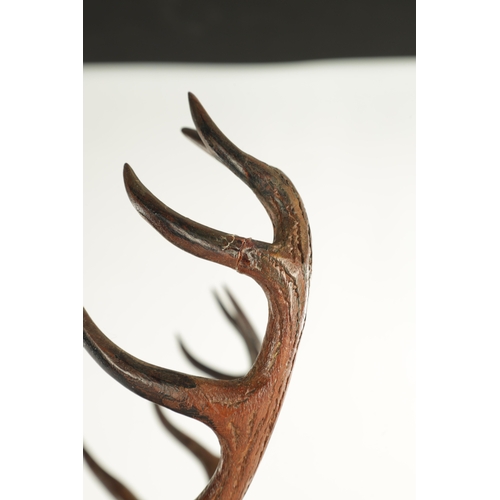 975 - A LARGE 19TH CENTURY CARVED LINDEN WOOD BLACK FOREST MANTEL CLOCK modelled as a stag amongst foliage... 