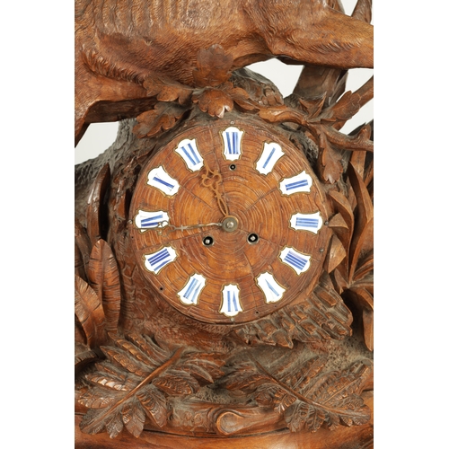 975 - A LARGE 19TH CENTURY CARVED LINDEN WOOD BLACK FOREST MANTEL CLOCK modelled as a stag amongst foliage... 