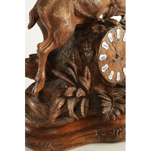 975 - A LARGE 19TH CENTURY CARVED LINDEN WOOD BLACK FOREST MANTEL CLOCK modelled as a stag amongst foliage... 