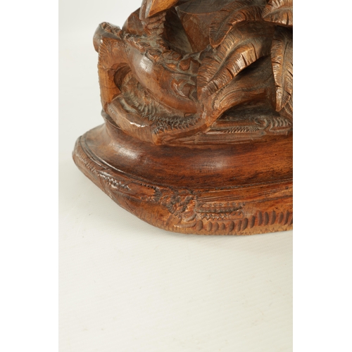 975 - A LARGE 19TH CENTURY CARVED LINDEN WOOD BLACK FOREST MANTEL CLOCK modelled as a stag amongst foliage... 