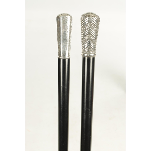 518 - TWO EARLY 20TH CENTURY GENTLEMANS EVENING CANES with silver tops and ebonised shafts - one hallmarke... 