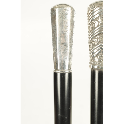 518 - TWO EARLY 20TH CENTURY GENTLEMANS EVENING CANES with silver tops and ebonised shafts - one hallmarke... 