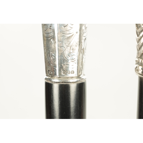 518 - TWO EARLY 20TH CENTURY GENTLEMANS EVENING CANES with silver tops and ebonised shafts - one hallmarke... 