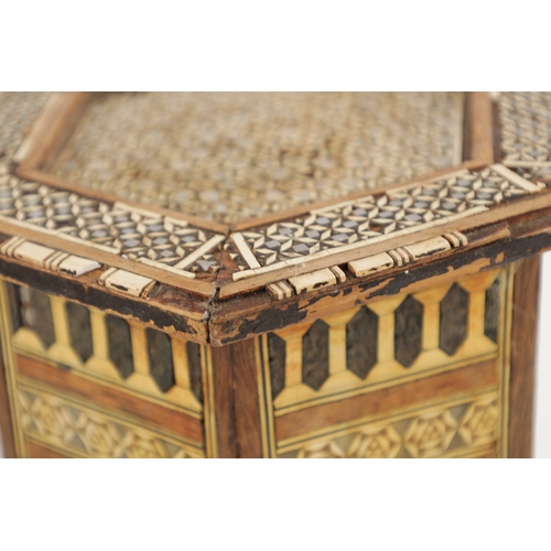 256 - A 19TH CENTURY MINIATURE ISLAMIC INLAID BONE AND MOTHER OF PEARL TABLE having a hexagonal shaped top... 