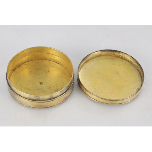 105 - AN EARLY 19TH CENTURY FRENCH SILVER GILT CIRCULAR SNUFF BOX with engraved floral decoration - hallma... 