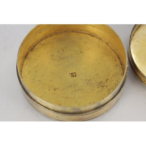 105 - AN EARLY 19TH CENTURY FRENCH SILVER GILT CIRCULAR SNUFF BOX with engraved floral decoration - hallma... 