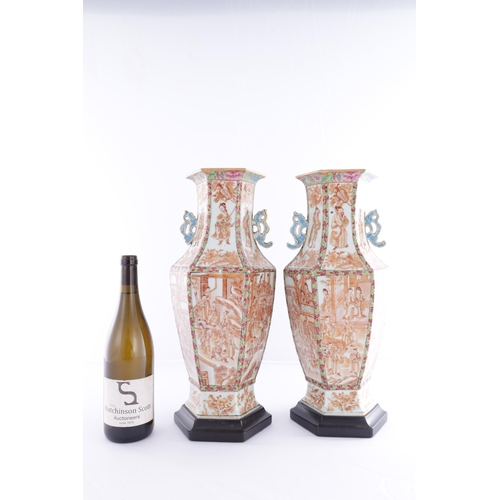 86 - A PAIR OF 18TH CENTURY CANTONESE CHINESE VASES of hexagonal form with shaped side handles, decorated... 